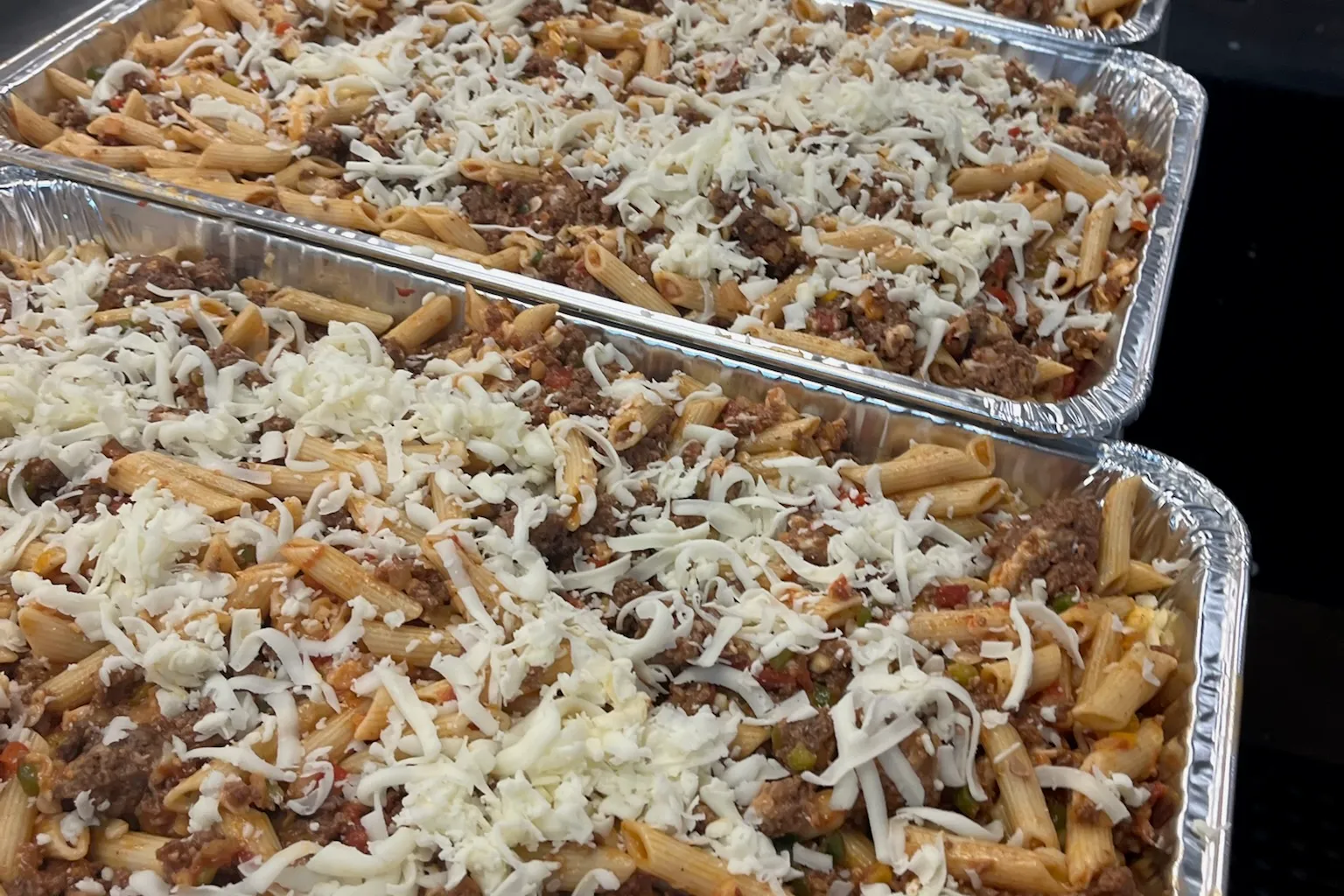 An image of trays of baked pasta