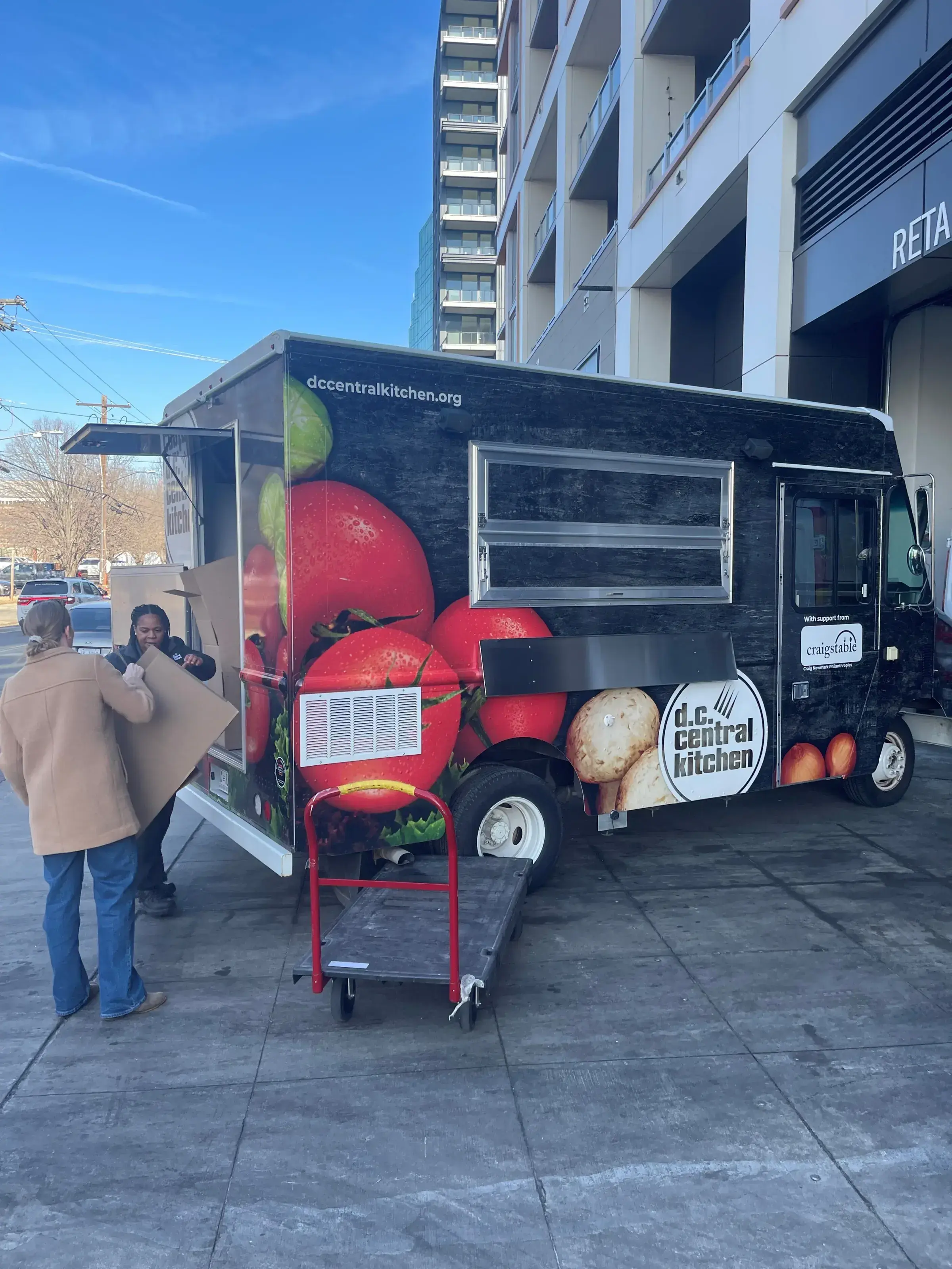 DC Central Kitchen staff loading its mobile meals vehicle with individually packaged meals earlier today.